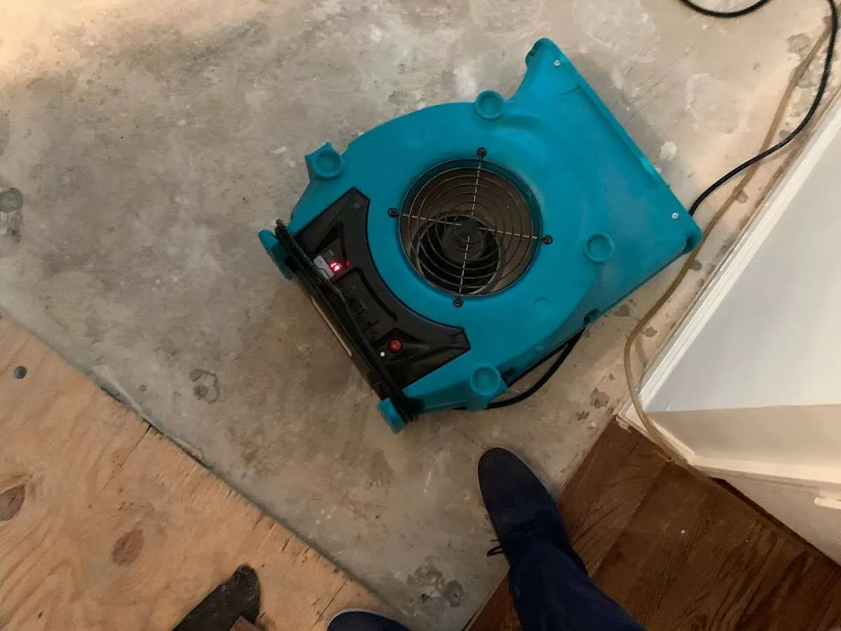 Air mover drying subfloor during Leak Detection & Repair in Waterford
